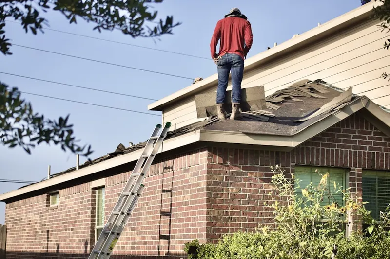 Professional roofer working on a residential roof in Pheasant Run Ranch